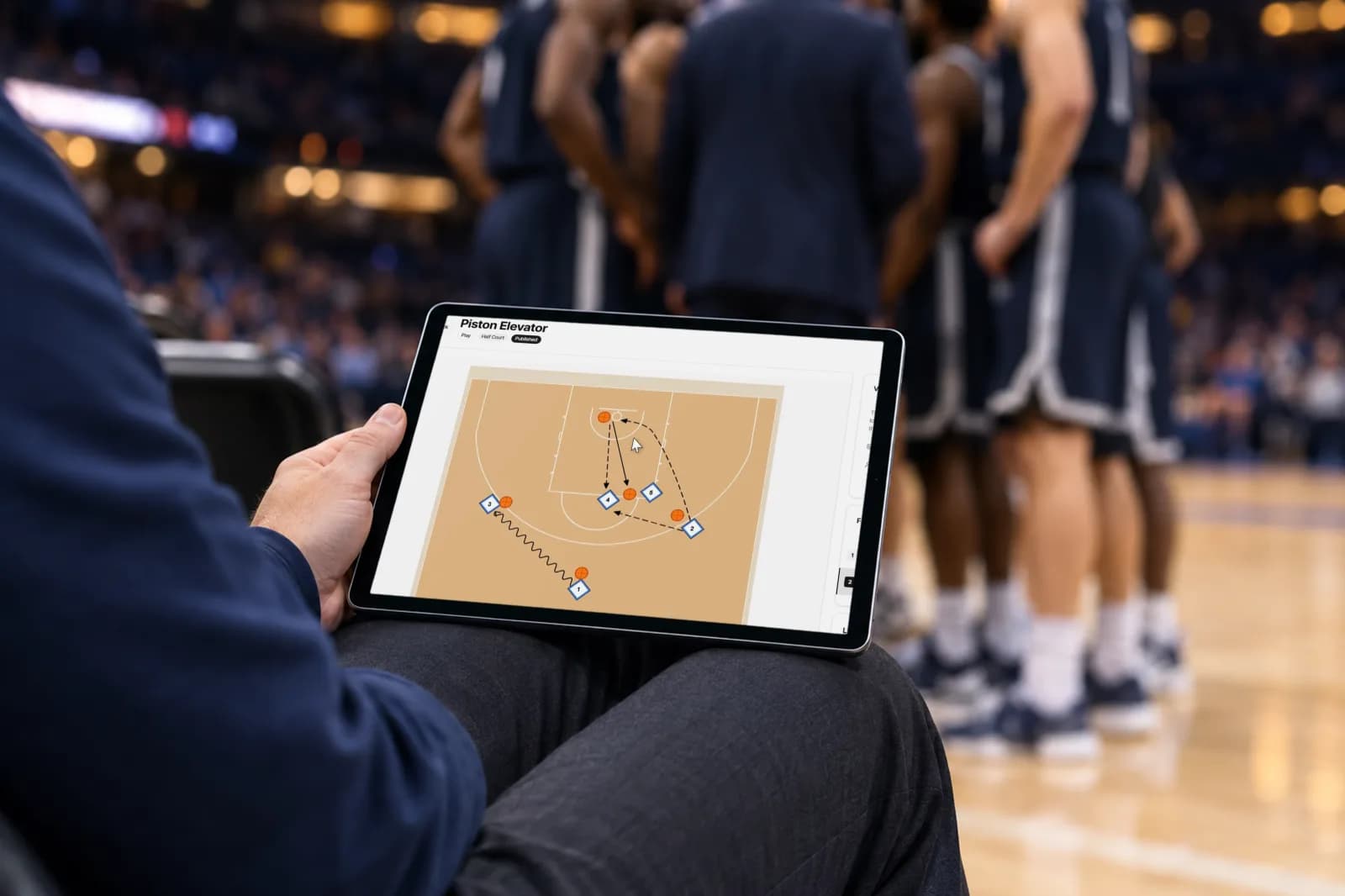 SpotBasket basketball playbook maker on an iPad at courtside showing an animated half-court play